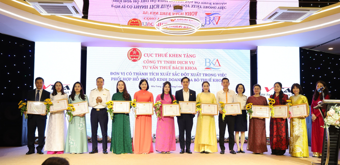Ông Nguyễn Ngọc Tú, Trưởng thuế Khánh Hòa và bà Nguyễn Thu Trà, Trưởng Ban Ban Quản lý tuân thủ và hỗ trợ người nộp thuế, Cục Thuế trao giấy khen của Cục Thuế và tặng hoa.
